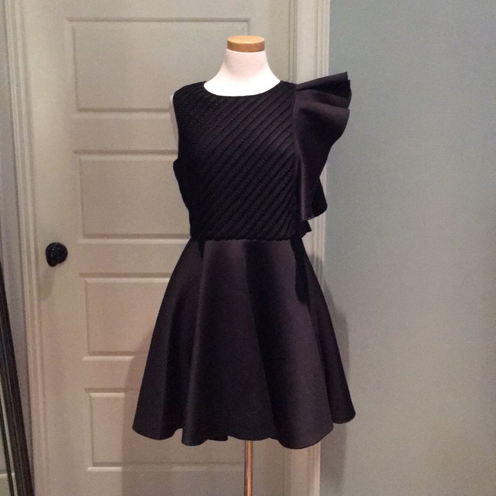 Samuel Dong black dress with ruffle detail.